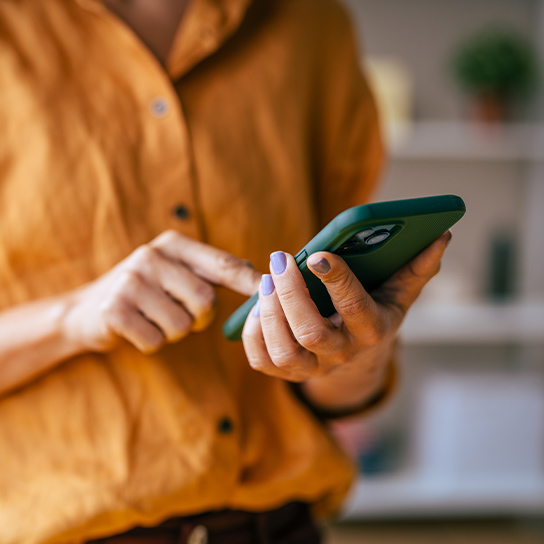 woman-orange-shirt-closeup-phone-1-1-544x544px