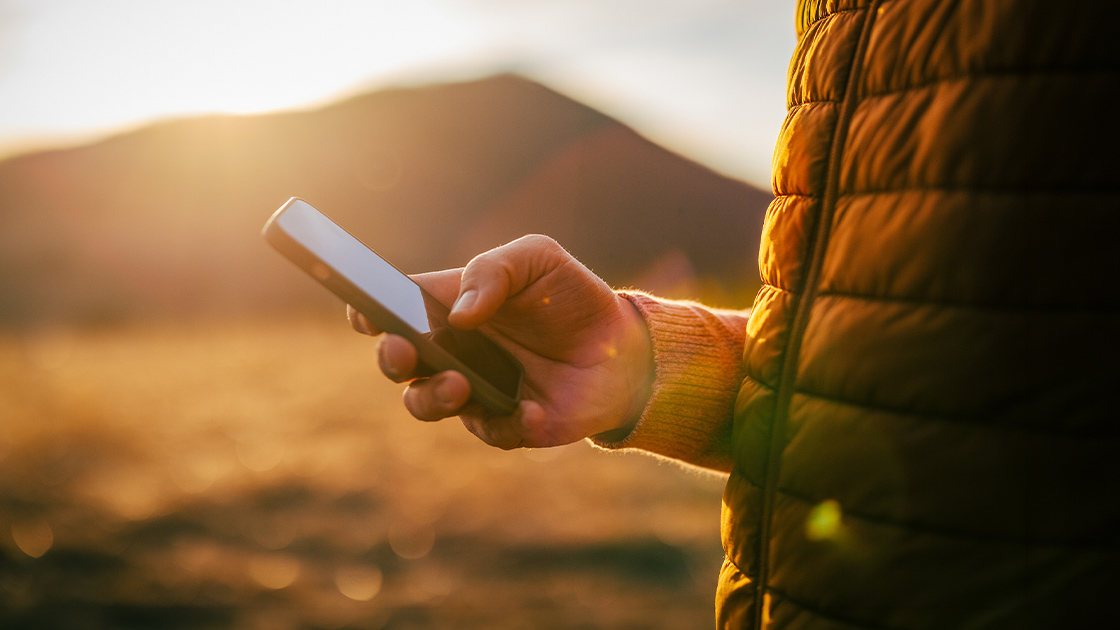 man-using-phone-outside-16-9-1120x630px