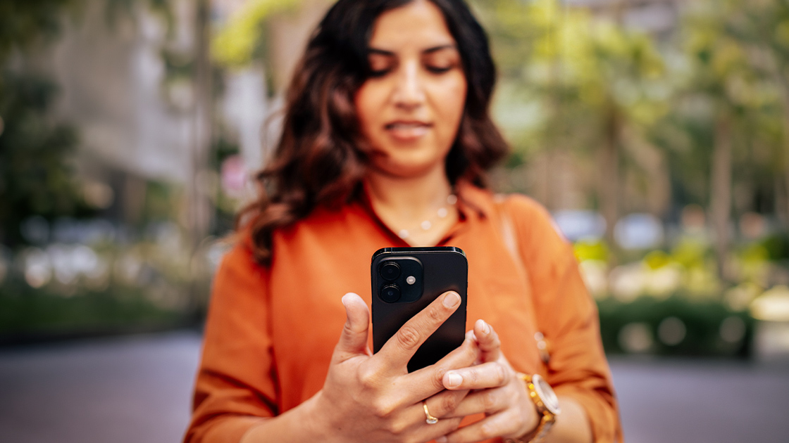 woman-using-phone-outside-closeup-16-9-1120x630px